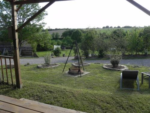 a garden with a swing set in the grass at Gîte de Rouviac in Castelnau-Pégayrols