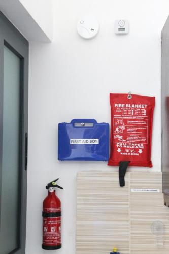 a wall with a fire bucket and a sign on it at XL Central Home - Sleeps 10 people in Pieta