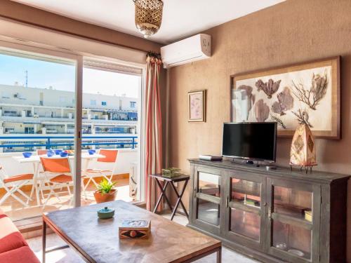 a living room with a flat screen tv on a cabinet at Apartment Las Terrazas by Interhome in Marbella