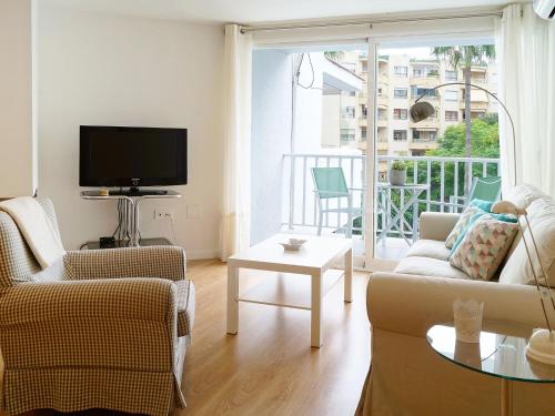 a living room with a couch and chairs and a tv at Apartment Fontanilla by Interhome in Marbella