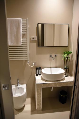 a bathroom with a sink and a toilet and a mirror at B&B Dimora Vistamare in Barletta