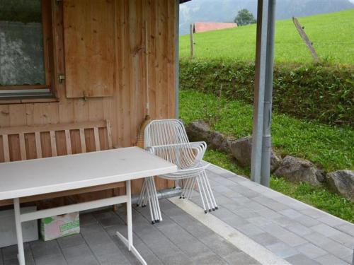 einen Tisch und zwei Stühle auf einer Terrasse in der Unterkunft Apartment Spillgerten-Blick by Interhome in Zweisimmen