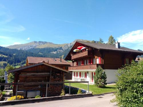 a large house with a mountain in the background at Apartment Bärnermutz # 1 by Interhome in Lenk