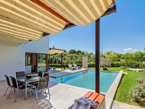 a patio with a table and chairs and a swimming pool at Villa Luna Nera by Interhome in Sveti Petar u Šumi
