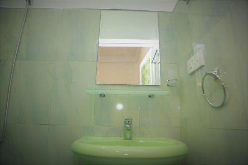 a bathroom with a sink and a mirror at Lanka Villa Mirissa in Mirissa