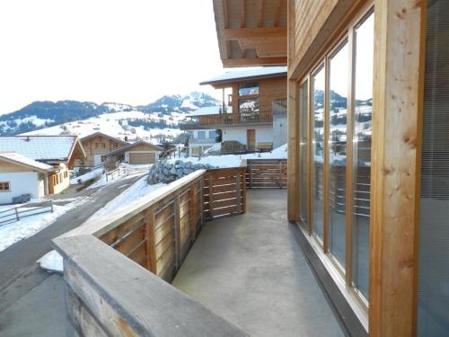 a balcony of a house with snow on the ground at Apartment Gletscherblick- Chalet by Interhome in Zweisimmen