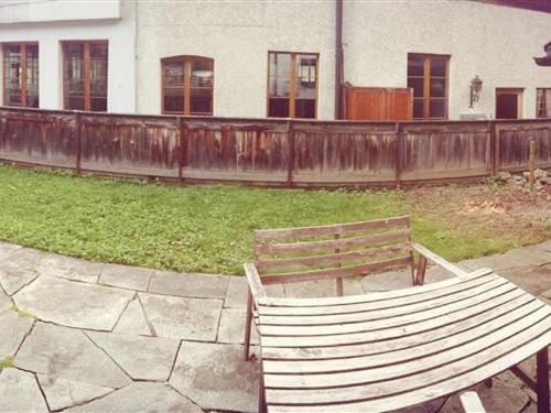 a wooden bench sitting in front of a fence at Apartment Oehrli by Interhome in Gstaad