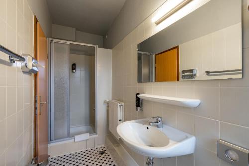a bathroom with a sink and a shower at a&o Hamburg Reeperbahn in Hamburg