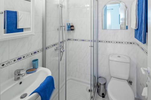 a bathroom with a shower and a sink and a toilet at 207 Kings Palace Seaview in Paphos City