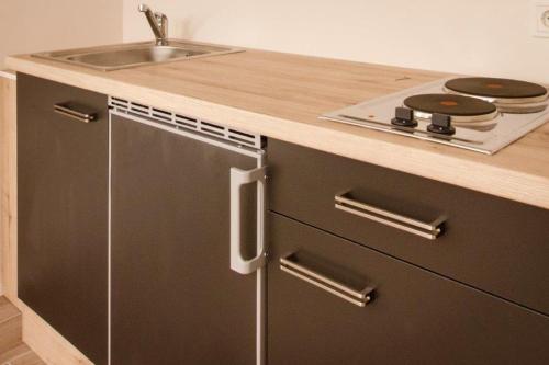 a kitchen with a sink and a stove at Bliesransbacher 8 in Saarbrücken