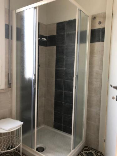 a shower with a glass door in a bathroom at LA DAMA ROOM&BREAKFAST in Russi