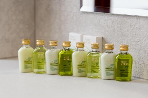 a group of four bottles of liquid on a counter at Lahovary Palace Hotel in Bucharest