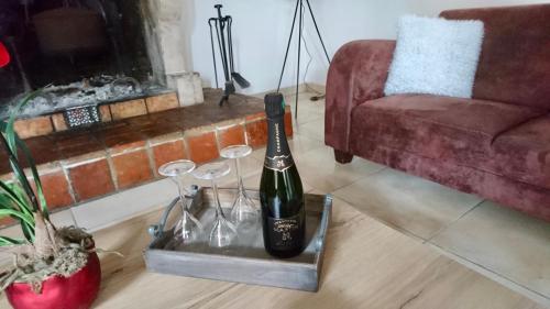 a bottle of wine on a tray in a living room at La Champenoise in Marson