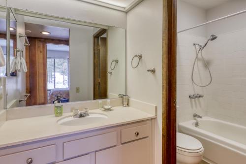 a bathroom with a sink and a toilet and a mirror at Sunshine Sanctuary in Mammoth Lakes