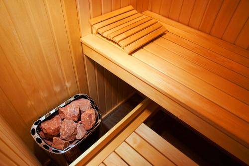 an inside of a sauna with a basket of rocks at Big Jacuzzi , Sauna , Khreshchatyk apartments in Kyiv