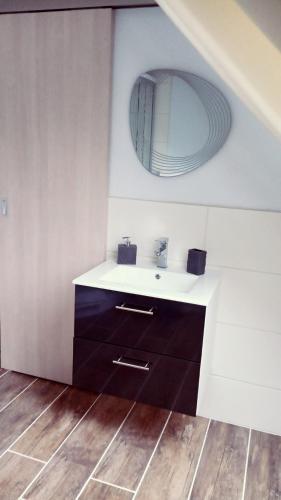 a bathroom with a sink and a mirror at Gästehaus - Café Frank in Antweiler