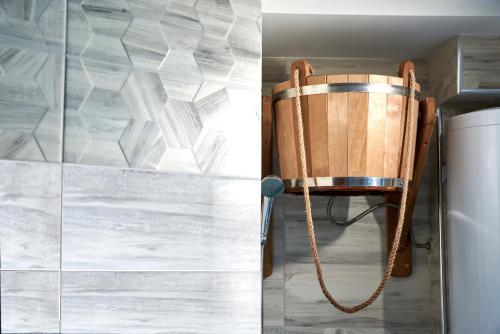a wooden chair with a rope tied to a wall at Sauna, Big Jacuzzi , Khreshchatyk apartments in Kyiv