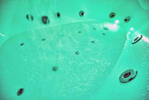 a bath tub filled with water with bubbles at Sauna, Big Jacuzzi , Khreshchatyk apartments in Kyiv