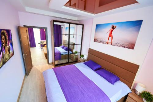 a bedroom with a bed and a picture of a woman on the wall at Sauna, Big Jacuzzi , Khreshchatyk apartments in Kyiv