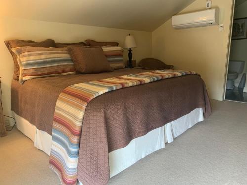 a bedroom with a large bed with a colorful blanket at Terrell House Bed and Breakfast in New Orleans