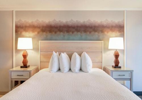 a bedroom with a white bed with two lamps at Hallmark Resort in Cannon Beach in Cannon Beach