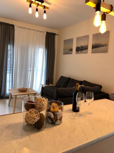 a living room with a table with glasses of wine at (L.I.H.8) Luxury Industrial House 8 in Nea Paphos