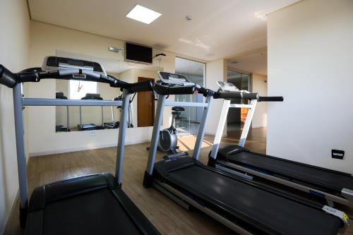 a gym with two tread machines in a room at Hotel Amsterdam Montes Claros in Montes Claros