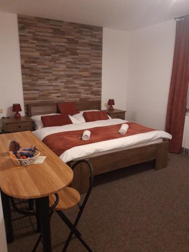 a hotel room with two beds and a table at Rodinný pension U Soudku in Rudník
