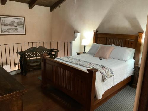 a bedroom with a large bed and a piano at Villas Emekarsa, Antigua in Antigua Guatemala