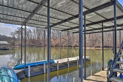a dock on a lake with a boat at Large Lavonia Home with Party Dock on Lake Hartwell! in Lavonia