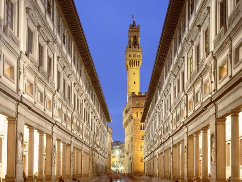 a city street with a clock tower in the distance at RistoriApartment in Florence