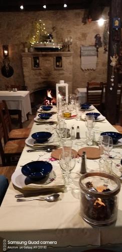 a long table with plates and glasses on it at Ble Mavi - Studio for 2 in Vouni
