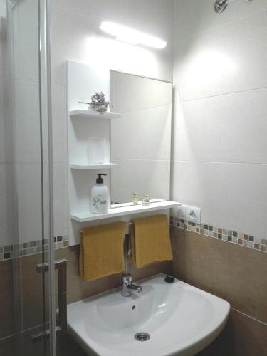 a bathroom with a sink and a mirror at cozy flat in Puerto del Rosario