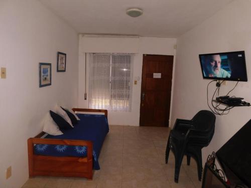 a bedroom with a bed and a flat screen tv at Las Dulcineas in La Paloma