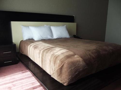 Ένα ή περισσότερα κρεβάτια σε δωμάτιο στο Hotel Cancalli Business & Suites
