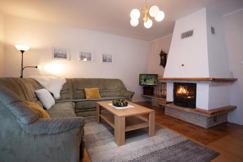 a living room with a couch and a fireplace at Chalupa U Miška in Hyby