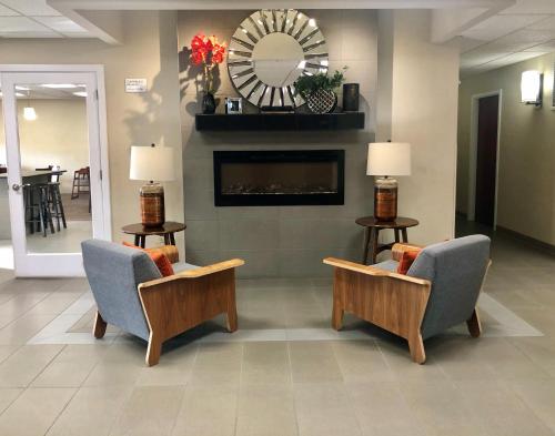 a lobby with two chairs and a fireplace at Ramada Limited - Mount Sterling in Mount Sterling