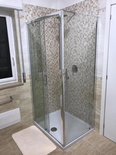 a shower with a glass door in a bathroom at COSTA APARTMENT NAPLES in Naples