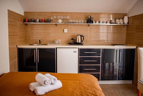 a small kitchen with two towels on a bed at Apartments Marković in Kotor
