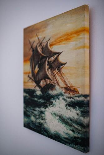 a painting of a ship in the ocean at Apartments Marković in Kotor