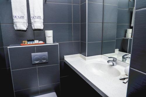 a bathroom with a sink and a mirror at Sky Roof Hotel in North Nicosia