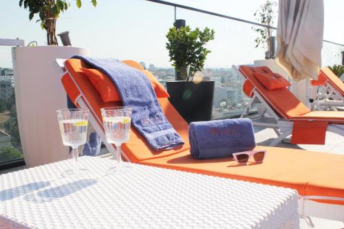 a balcony with a table and two glasses of water at Sky Roof Hotel in North Nicosia