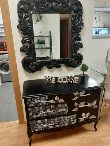 a mirror on a wall above a dresser with shoes at Arroyo in Coreses