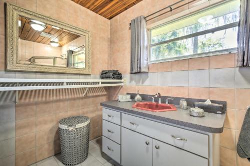 a bathroom with a sink and a mirror at Rainbow River Oasis with Kayaks and Furnished Sunroom! in Dunnellon