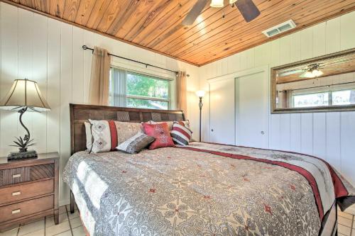 a bedroom with a bed and a wooden ceiling at Rainbow River Oasis with Kayaks and Furnished Sunroom! in Dunnellon