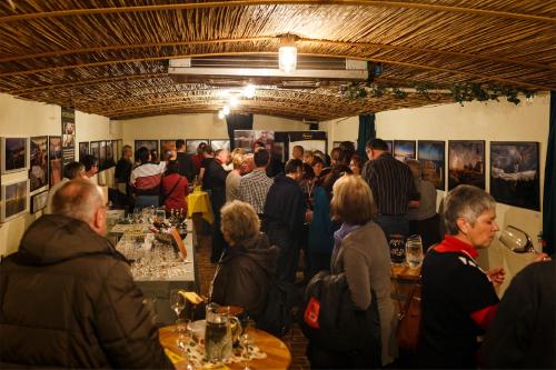 a crowd of people standing in a room at a party at Wein & Landhaus Willi Opitz in Illmitz