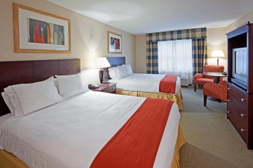 a hotel room with two beds and a television at Holiday Inn Express Hotel & Suites Freeport by IHG in Freeport