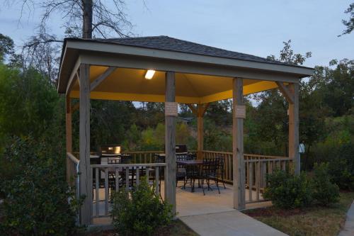 a gazebo with a table and chairs under it at Candlewood Suites Pearl by IHG in Pearl