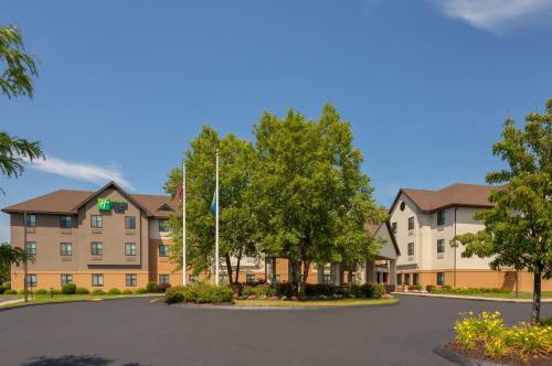 a rendering of an apartment building with a parking lot at Holiday Inn Express & Suites Bradley Airport by IHG in Windsor Locks
