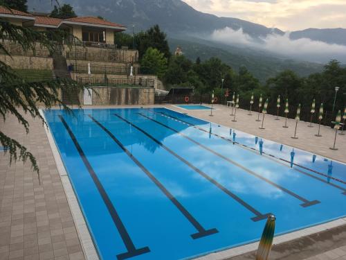 a large swimming pool with blue water at Residence ELIOS in Caramanico Terme